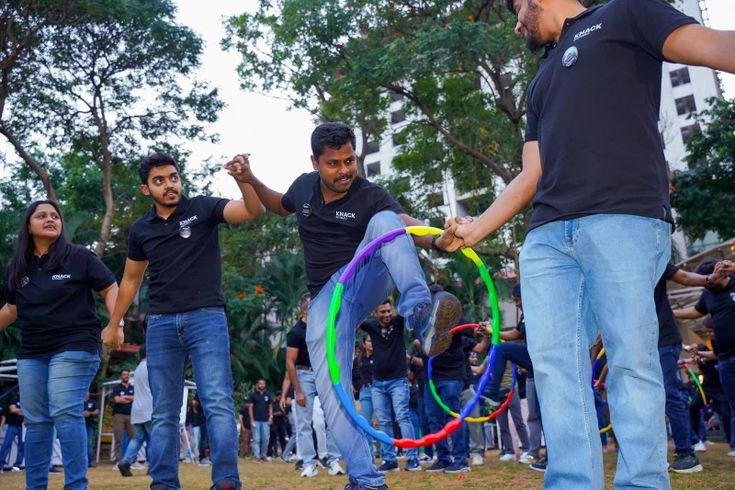 Colleagues supporting each other through an outdoor team challenge