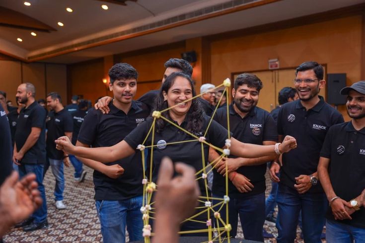 Team celebrating a completed activity at an indoor workshop