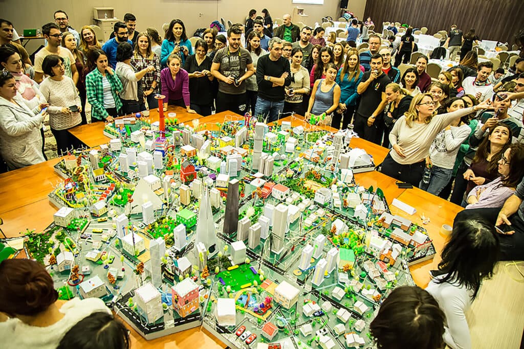 The City Build Challenge – A Large-Scale Collaborative Team Building Experience AI experience