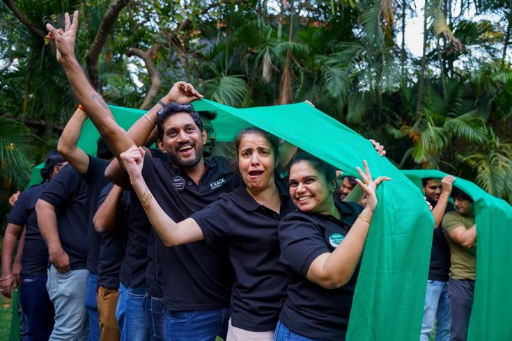 Team celebrating outdoors during a branded offsite activity